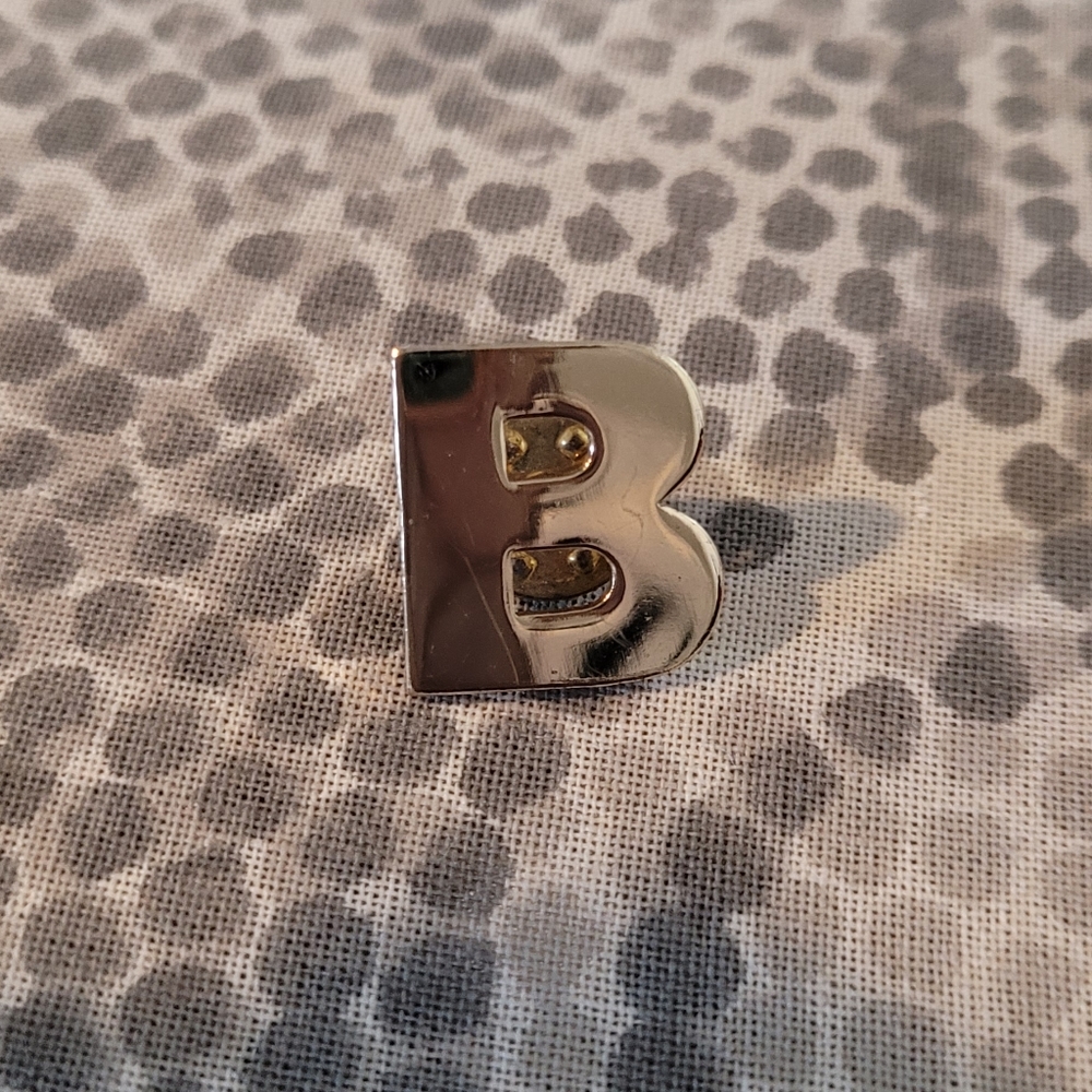 Gold tone "B" lapel pin